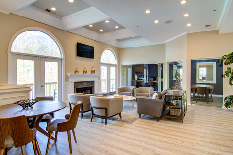 a living room with couches and chairs and a fireplace